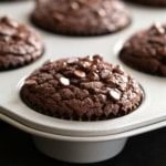 flourless chocolate muffins with mini chocolate chips in metal muffin tin