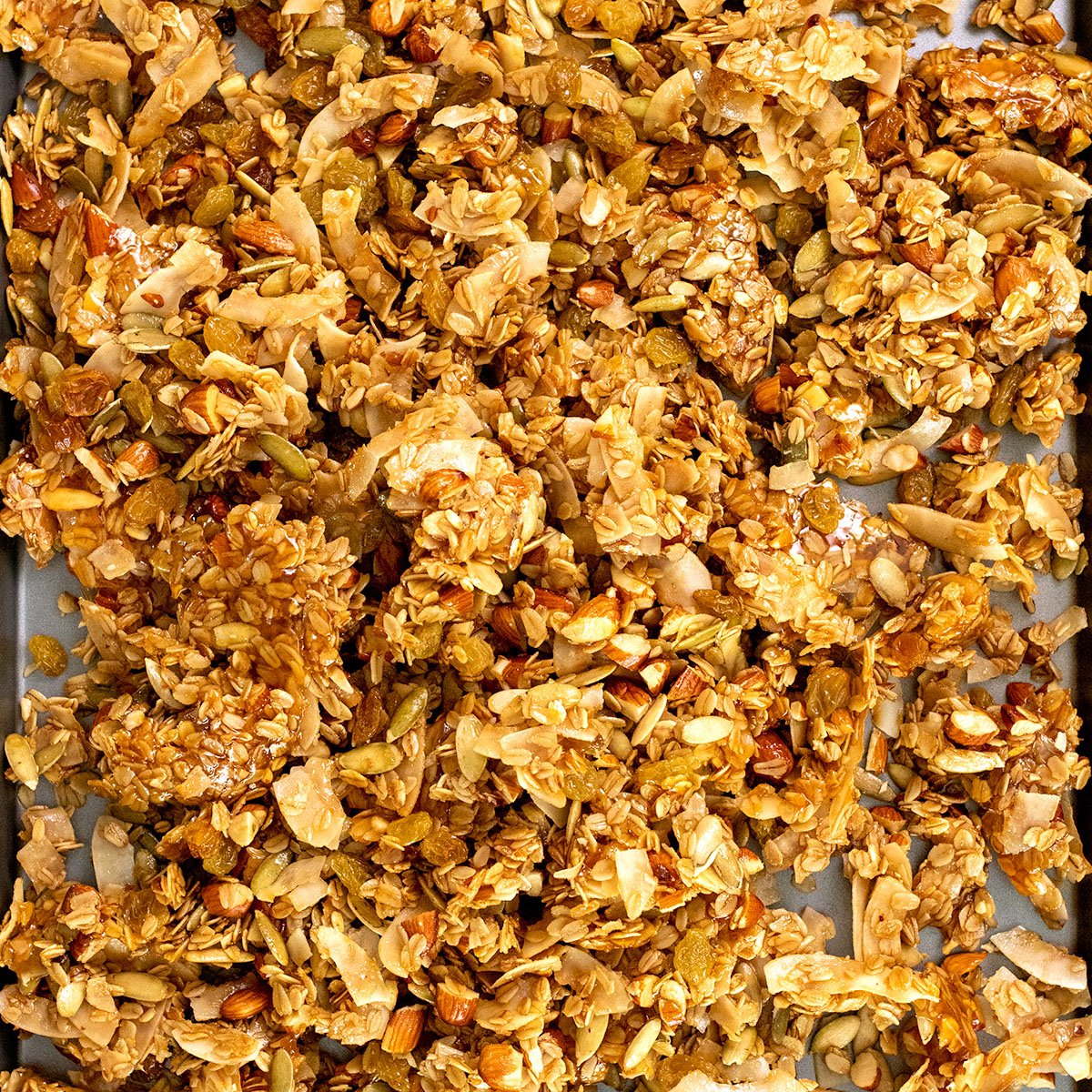 overhead image of gluten free granola clusters cooling on baking sheet