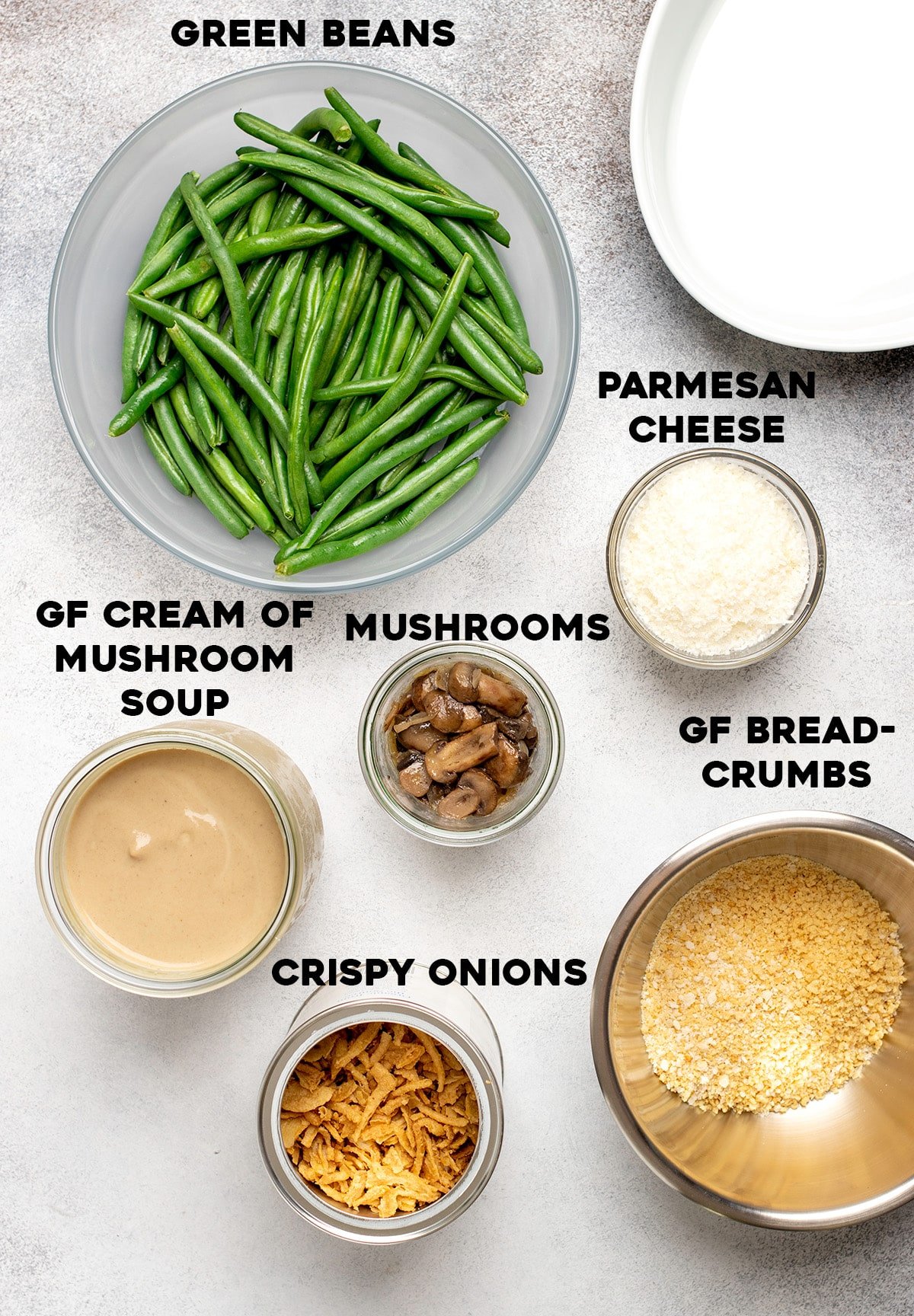 Overhead image of green beans, cooked mushrooms, grated parm, cream of mushroom soup, crispy fried onions and gluten free breadcrumbs