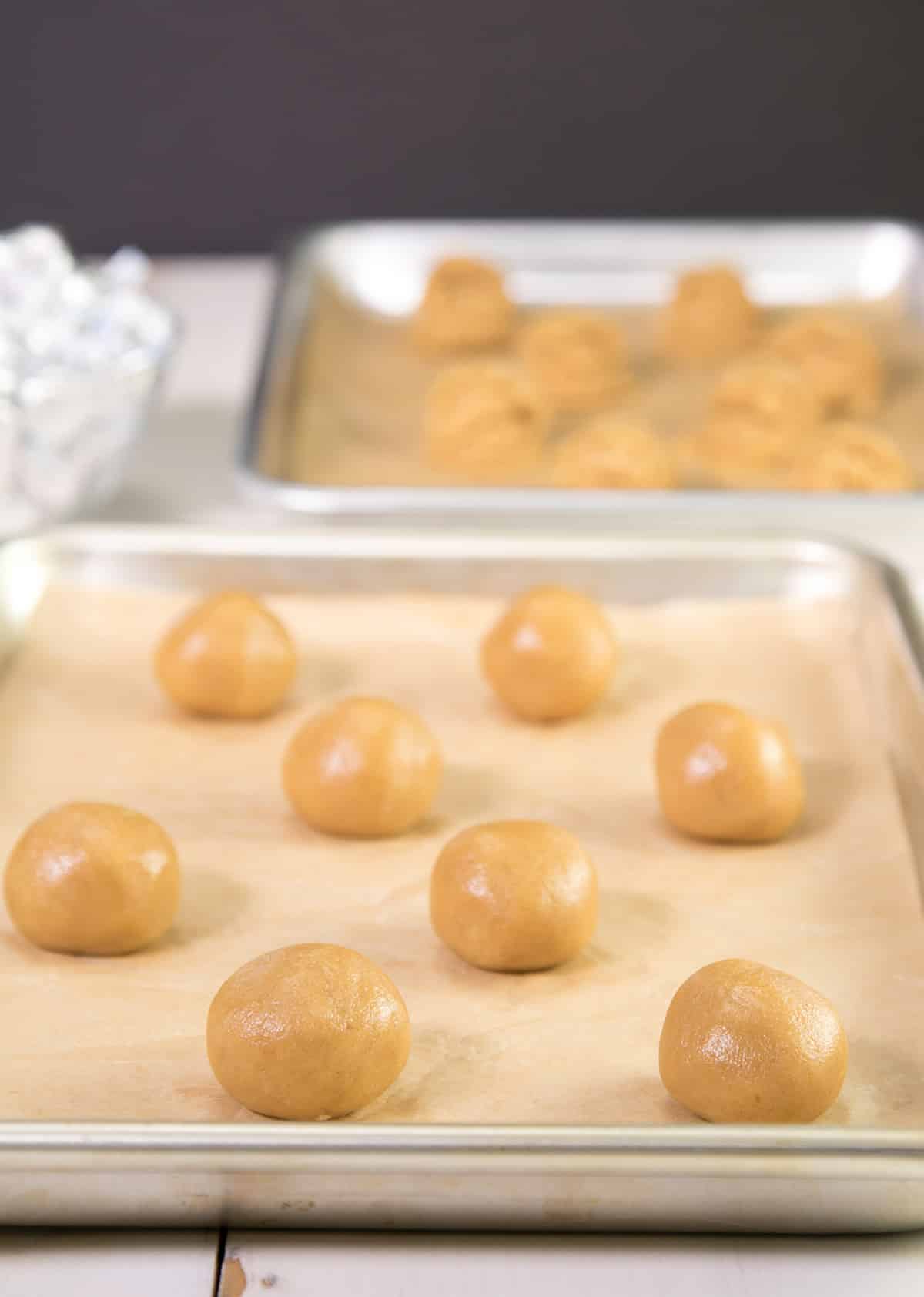 A tray with balls of peanut butter blossom cookie dough