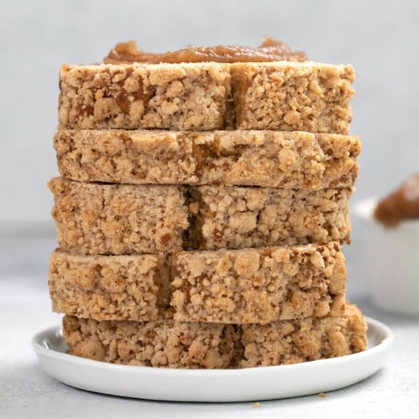 stack of 5 slices of light brown apple bread with crumble topping