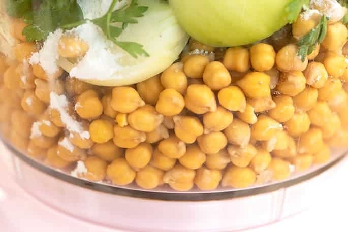 Soaked chickpeas onions and herbs in food processor