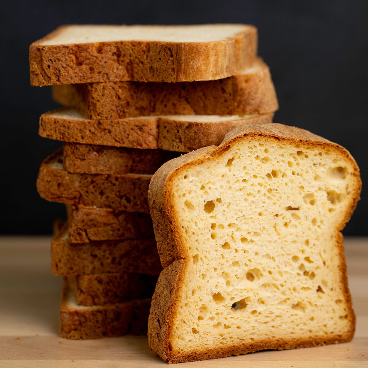 stack of 12 slices of gluten free potato bread with one more slice standing up