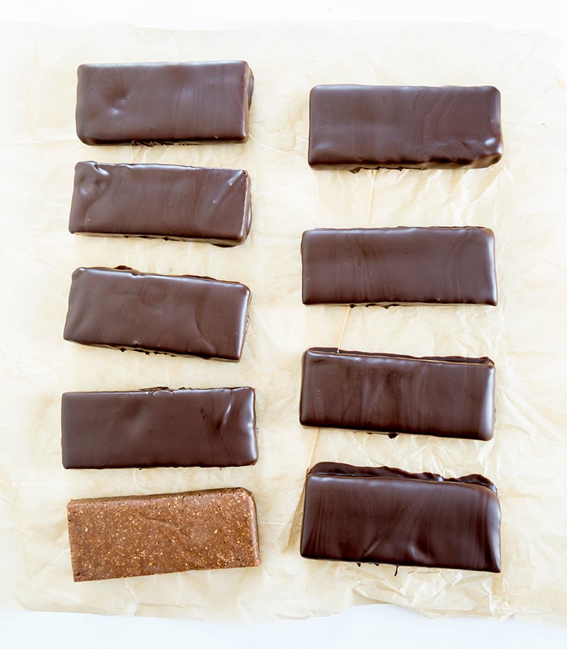 homemade protein bars covered in chocolate and one without chocolate