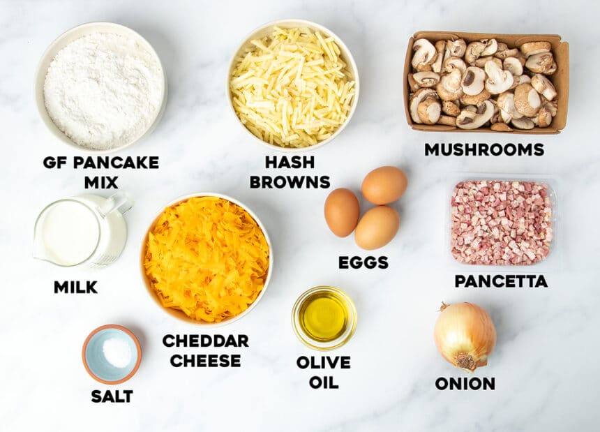 ingredients in gluten free breakfast casserole with names of ingredients in small bowls and black block lettering spelling out name of each ingredient