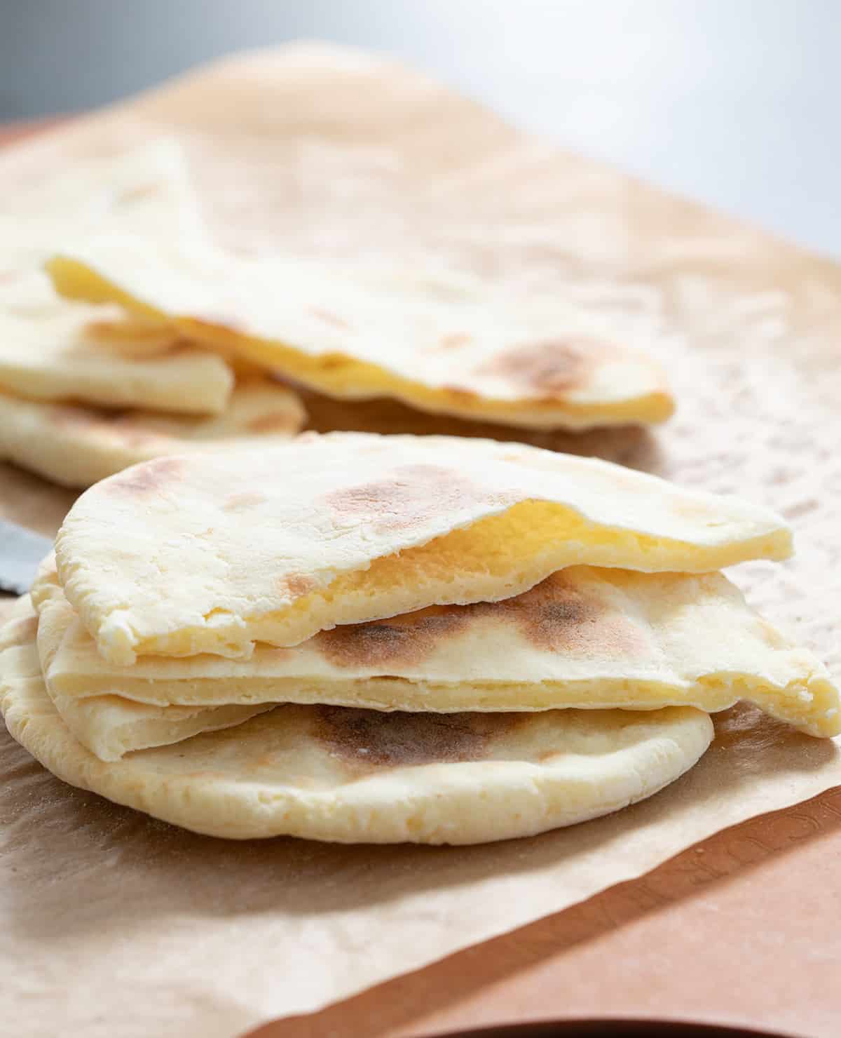 Yeast free gluten free pita breads just out of the oven, sliced open.
