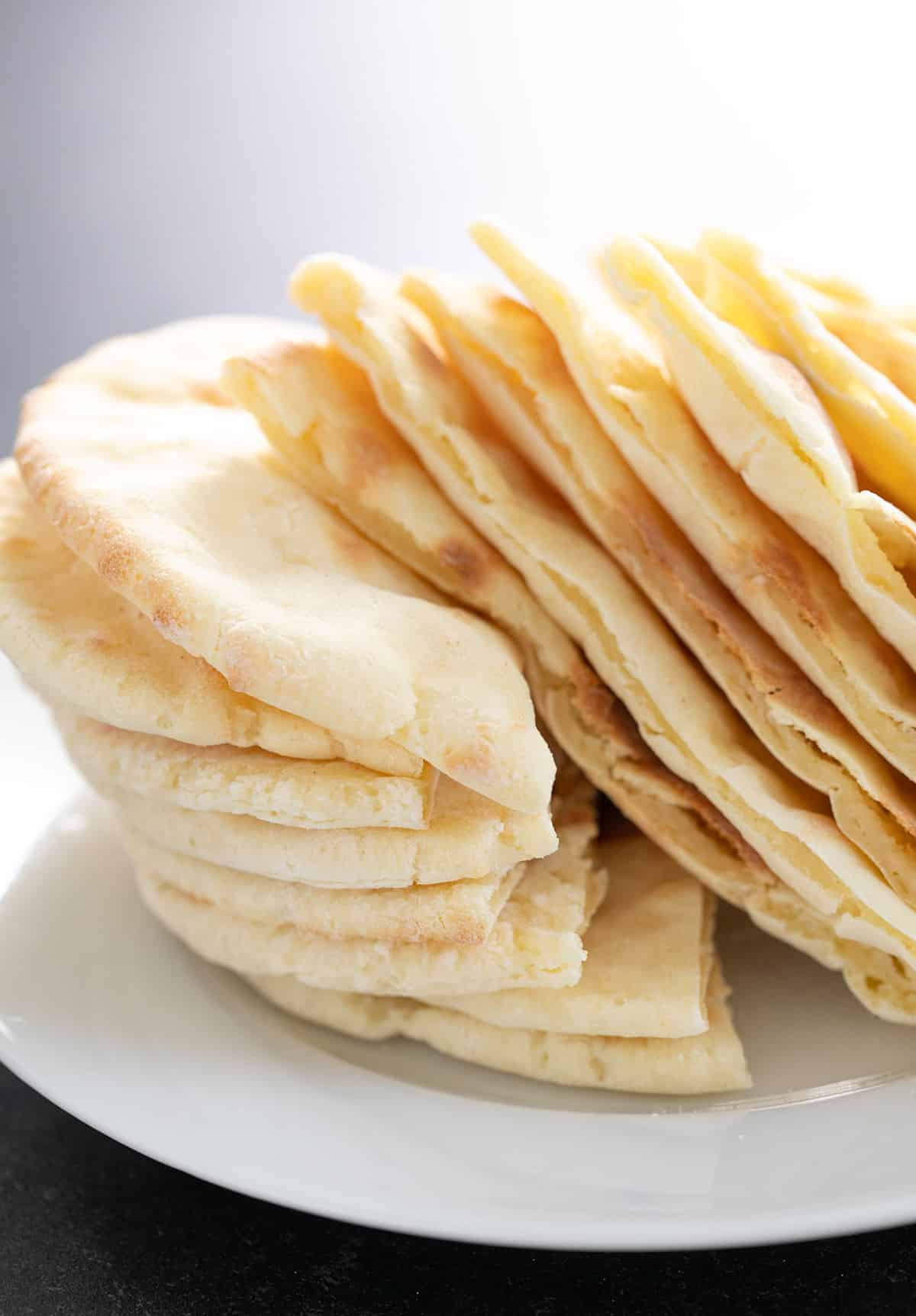 Stack of yeast free gluten free pita breads, sliced and ready to serve