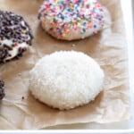 3 gluten free drop sugar cookies covered in chocolate sprinkles, coarse sugar, and nonpareils on brown paper