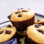 gluten free chocolate chip muffins in wire basket with blue and white striped cloth