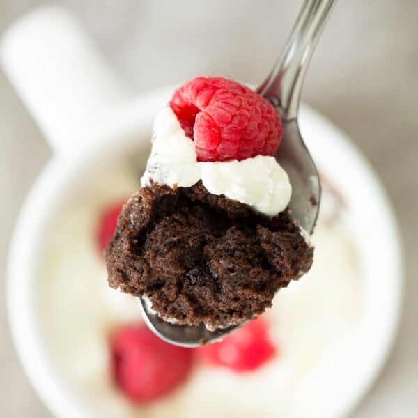 gluten free chocolate mug cake spoonful with berry and cream