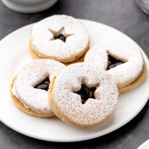 4 gluten free linzer cookies on small white plate