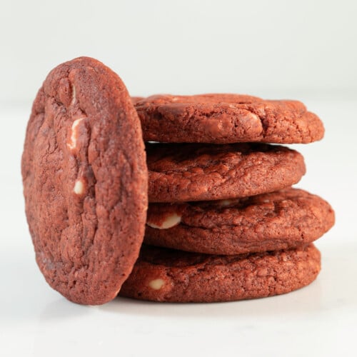 stack of 4 gluten free red velvet chocolate chip cookies with one on its side