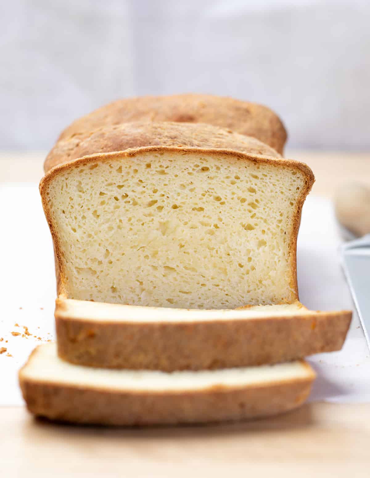 Closeup image of loaf of bread with 2 slices cut