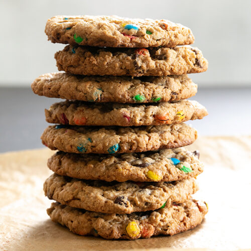 stack of gluten free monster cookies on brown paper