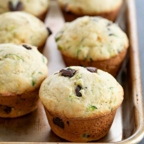 6 zucchini muffins on rimmed baking sheet