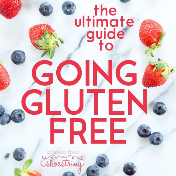 ultimate guide to going gluten free words with strawberries and blueberries on marble surface