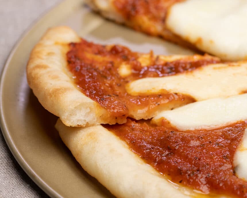 Closeup image of pizza with sauce and cheese made with Caputo gluten free flour