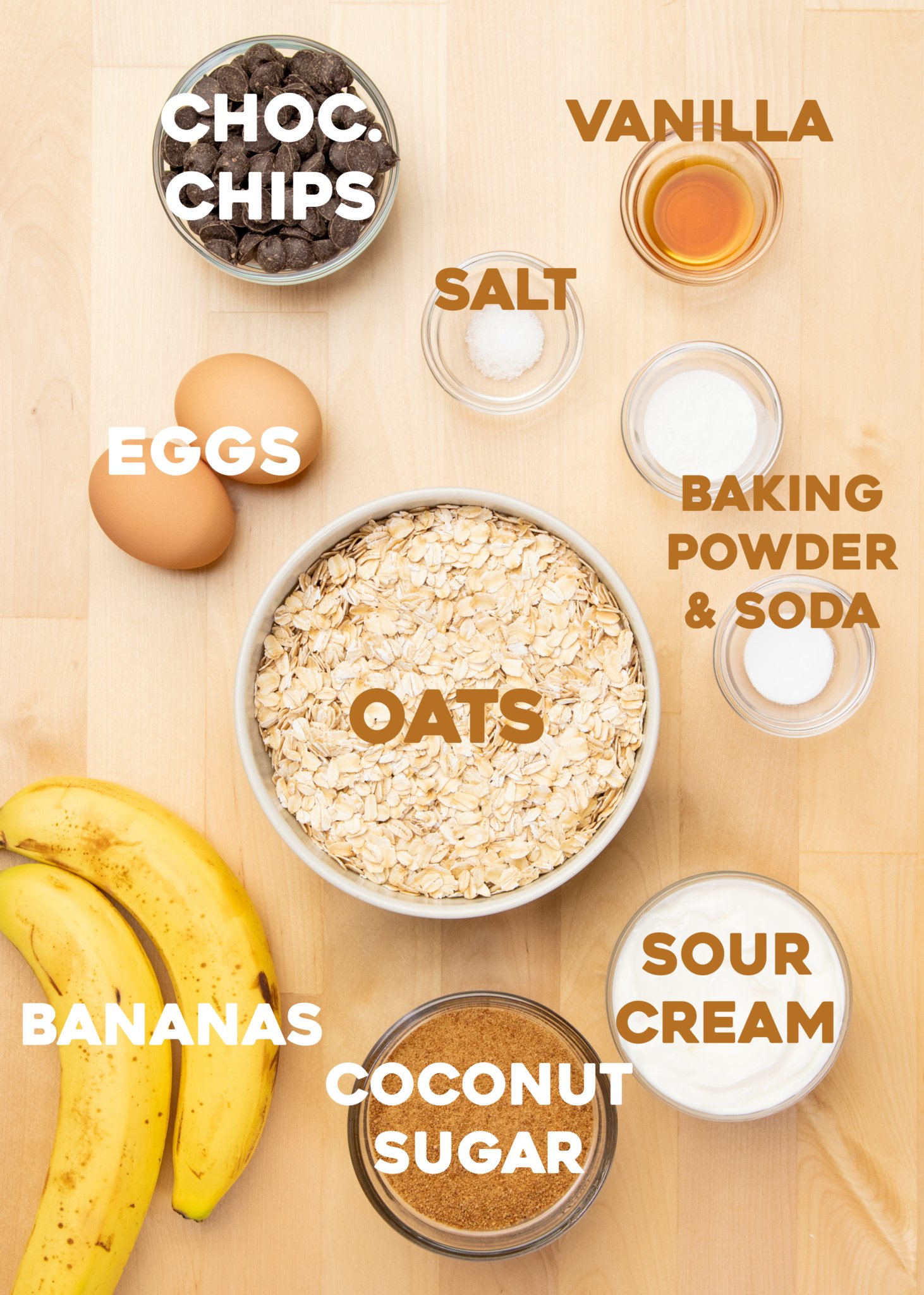 chocolate chips, salt, vanilla, eggs, baking powder, baking soda, oats, sour cream, coconut sugar and 2 bananas