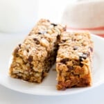 2 gluten free granola bars with raisins and chocolate chips on a small white plate