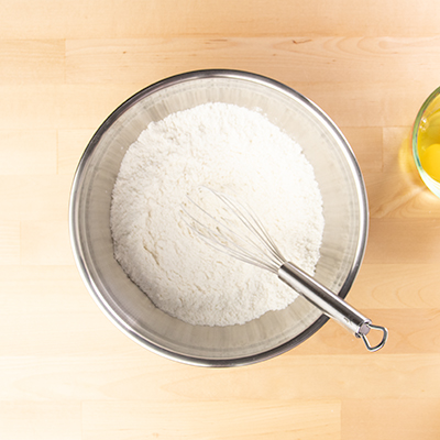 Pancake dry mix in metal bowl with whisk