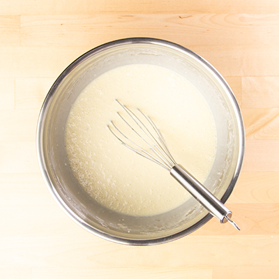 Sheet pan pancake batter whisked in bowl