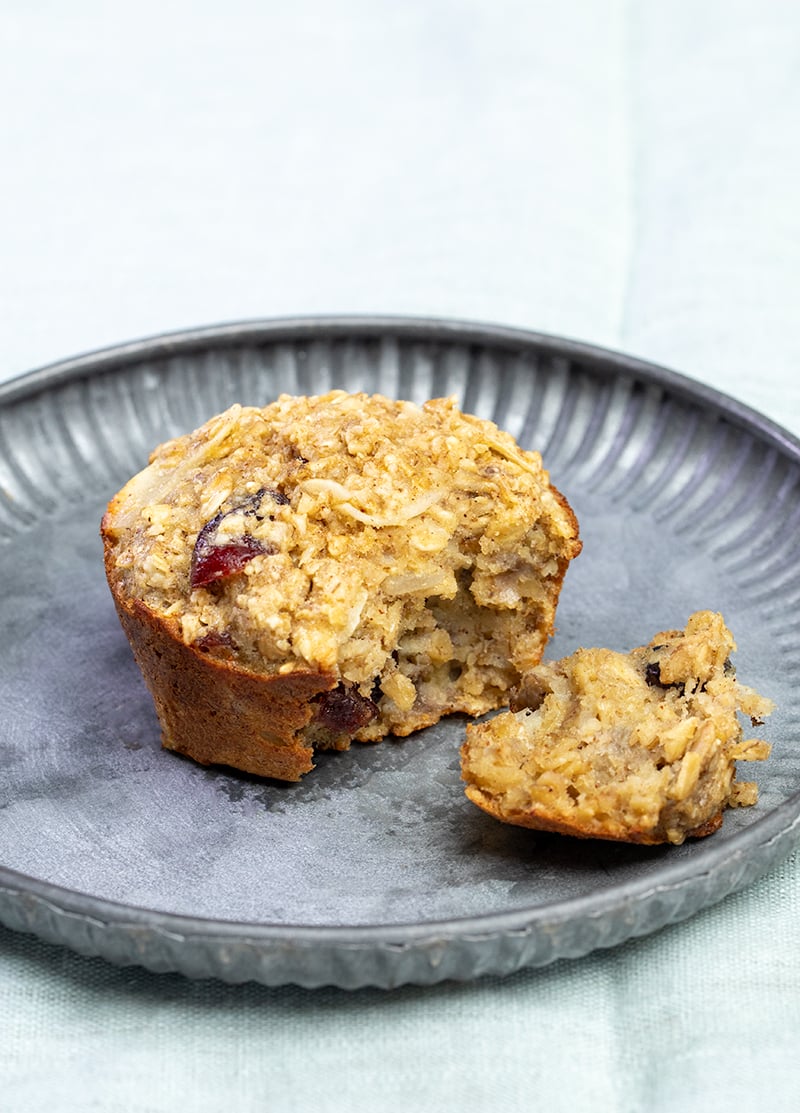 one broken baked oatmeal cup on gray plate on light blue cloth