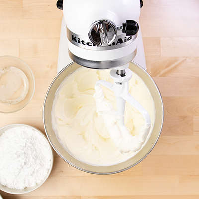 Beaten cream cheese and sour cream in stand mixer with paddle attachment