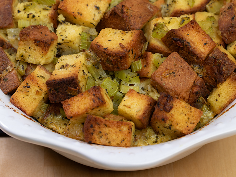 Closeup of gluten free stuffing baked in white casserole dish