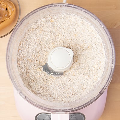 Ground oats in food processor bowl