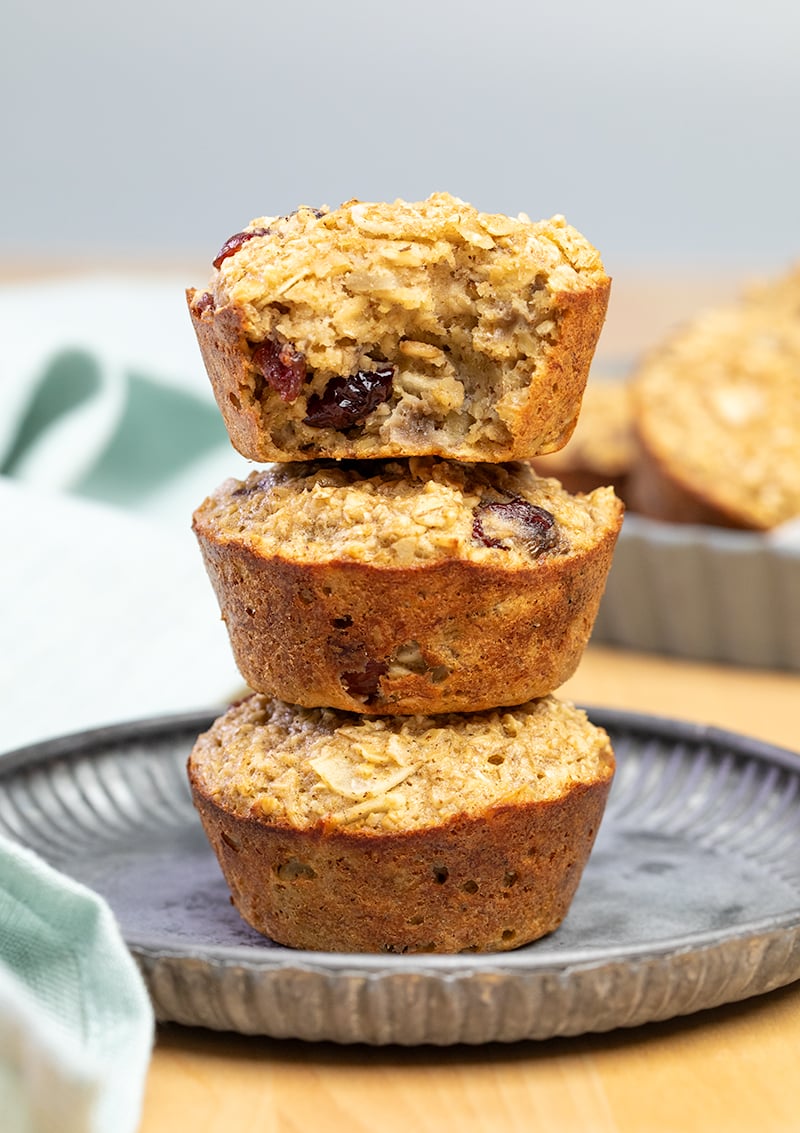 vertical stack of 3 baked oatmeal cups on gray plate