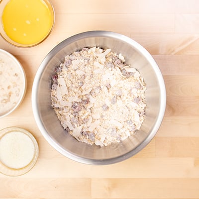 mixed dry ingredients for baked oatmeal cups in metal mixing bowl