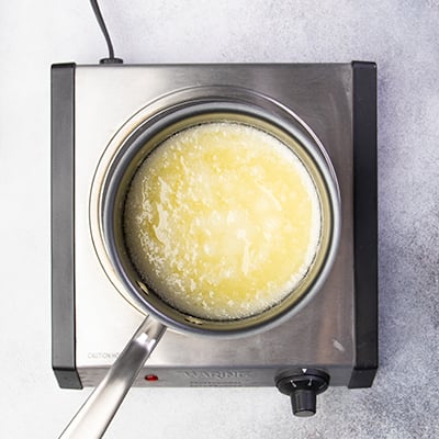 Simmering melted butter and sugar in saucepan on burner