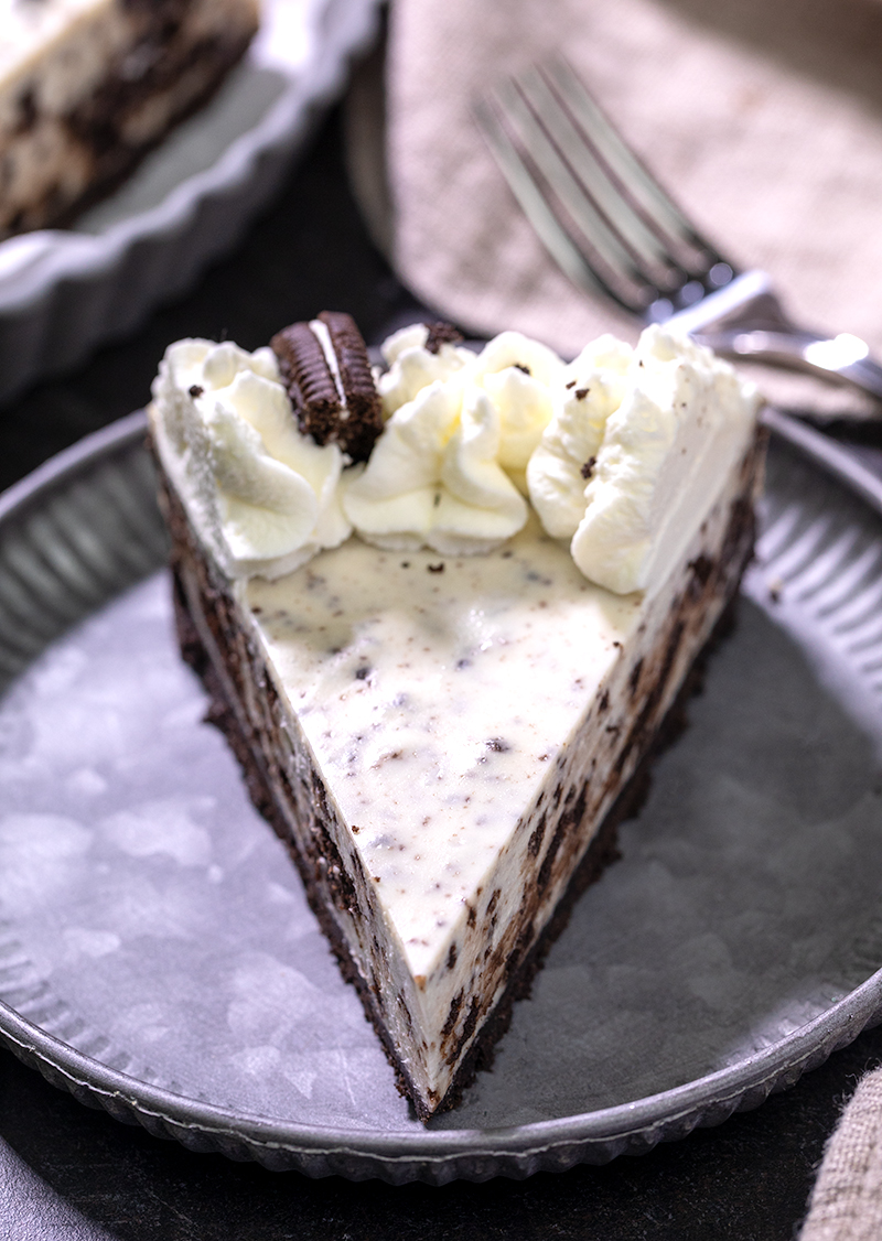 Slice of no bake Oreo cheesecake on small gray plate