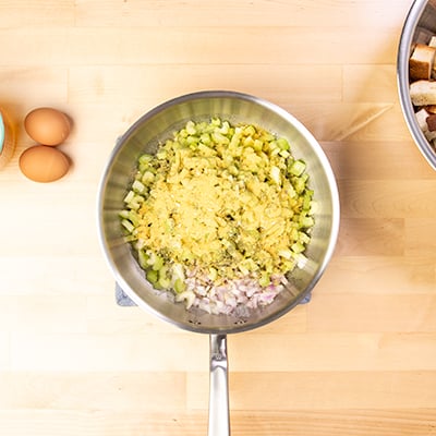 Uncooked aromatics and spices in saucepan