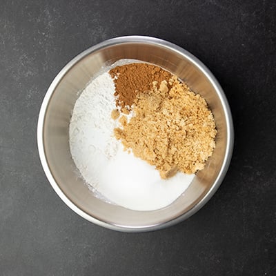 Unmixed dry ingredients of gluten free pumpkin bread in metal round mixing bowl