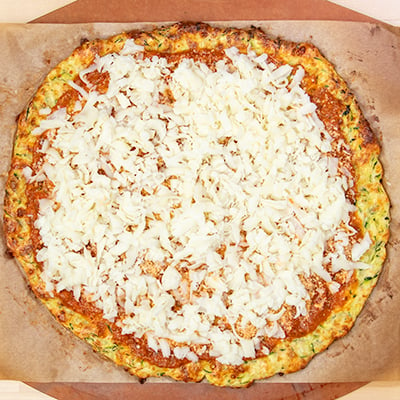 Zucchini pizza with sauce and cheese toppings unbaked