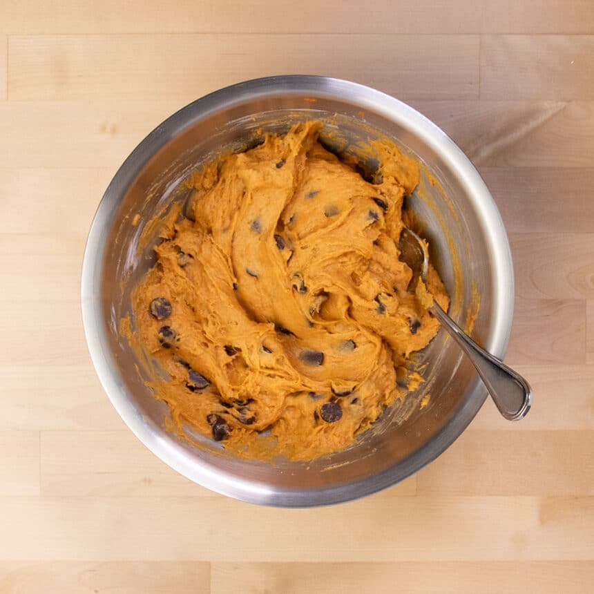 raw orange muffin mixture with chocolate chips mixed in