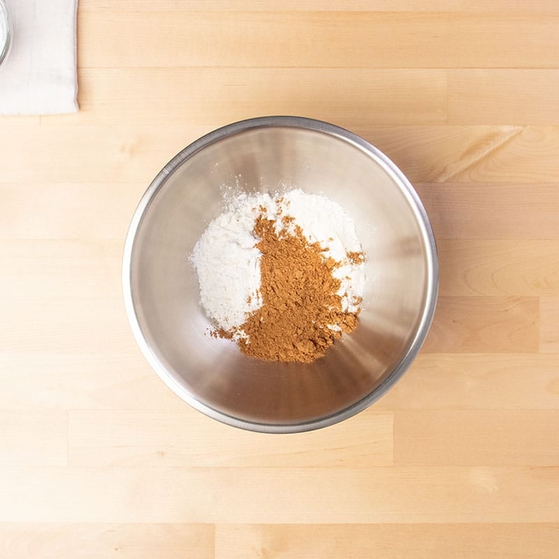 white and brown dry ingredients in small metal mixing bowl