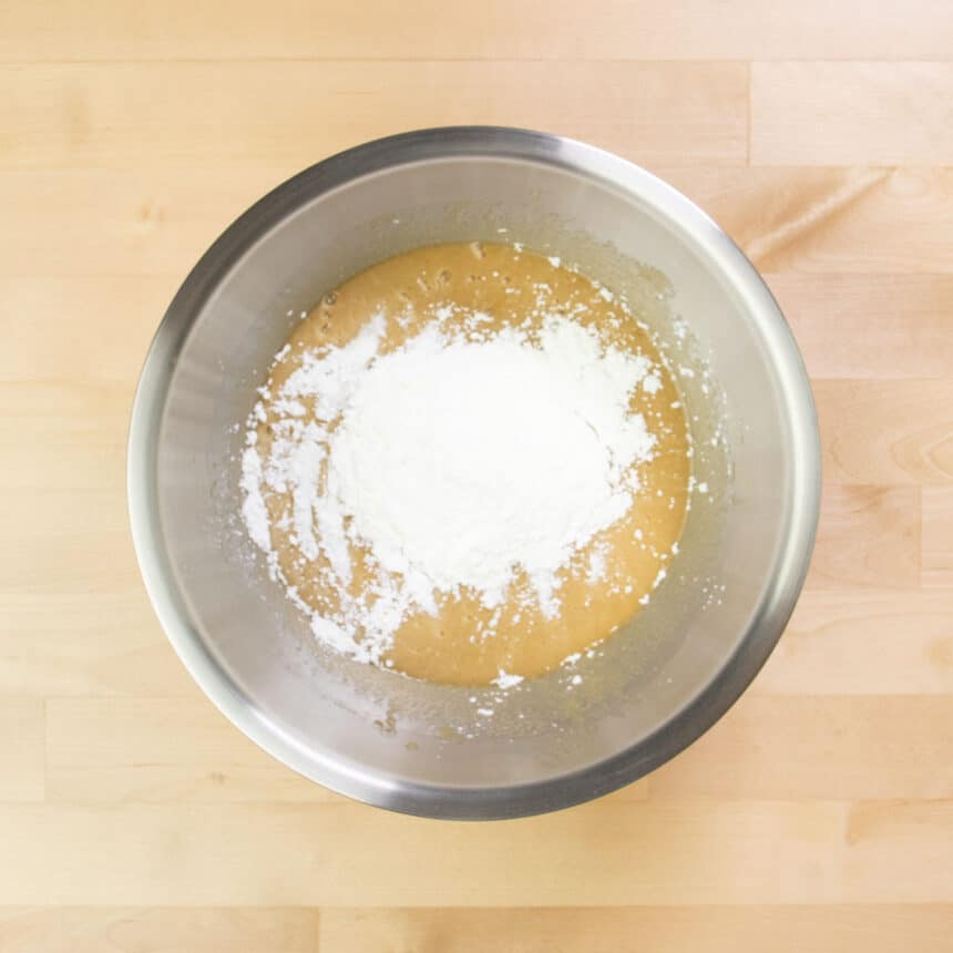 same metal mixing bowl with white powdered cornstarch on top