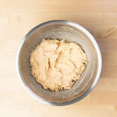 raw chicken meatball mixture in mixing bowl