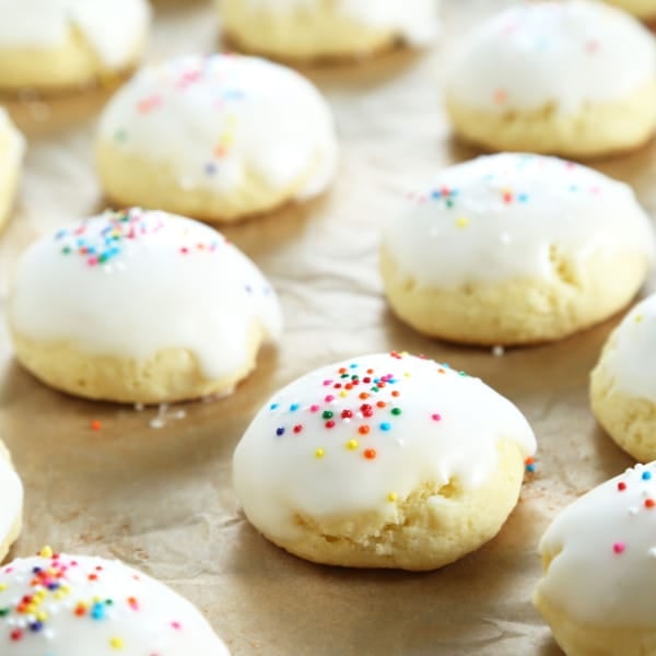 gluten free anisette cookies with icing and nonpareils on brown paper