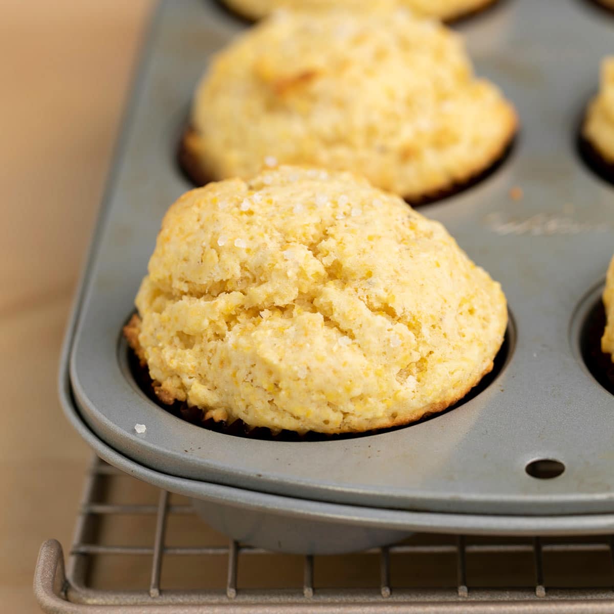 gluten free corn muffins in muffin tin on wire rack