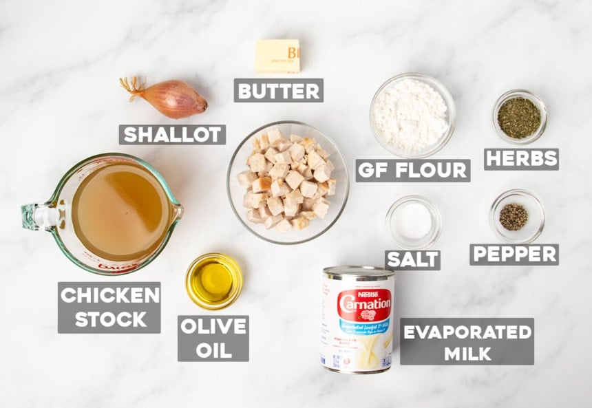 ingredients for gluten free cream of chicken soup laid out in small bowls and a can with words for names of ingredients