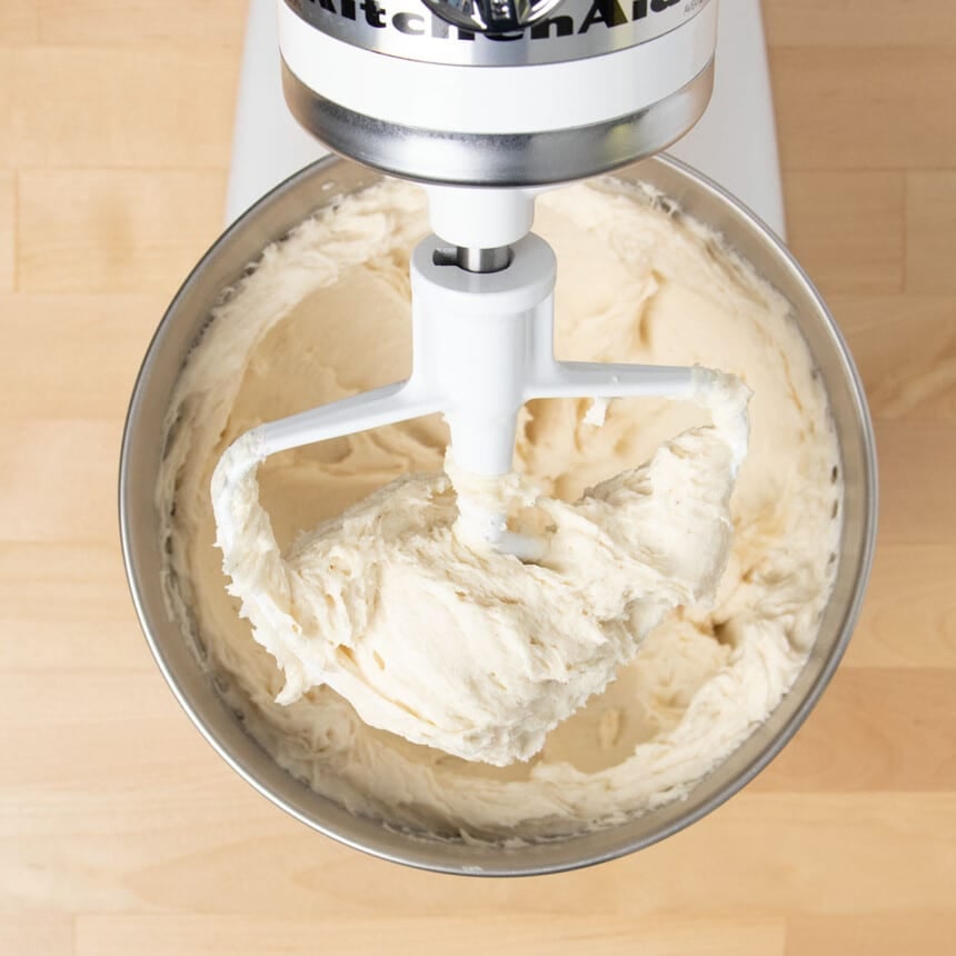 raw whipped-looking gluten free donut dough in mixing bowl with KitchenAid mixer paddle attachment