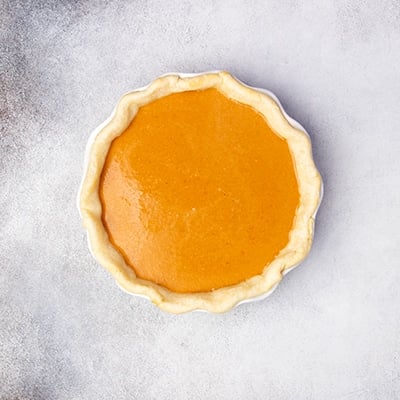 same parbaked light brown pie crust with unbaked orange liquid inside