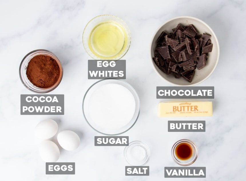 flourless chocolate cake ingredients in small bowls on white surface