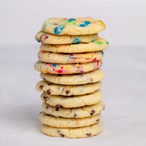 tall stack of 3 different types of gluten free cake mix cookies on white paper