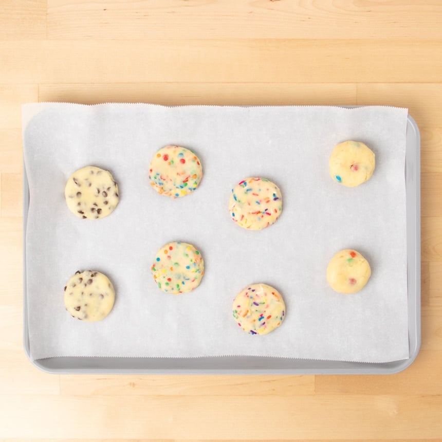 8 disks of raw cookie dough with mini chocolate chips, edible colored confetti, colored sprinkles, or mini M&Ms