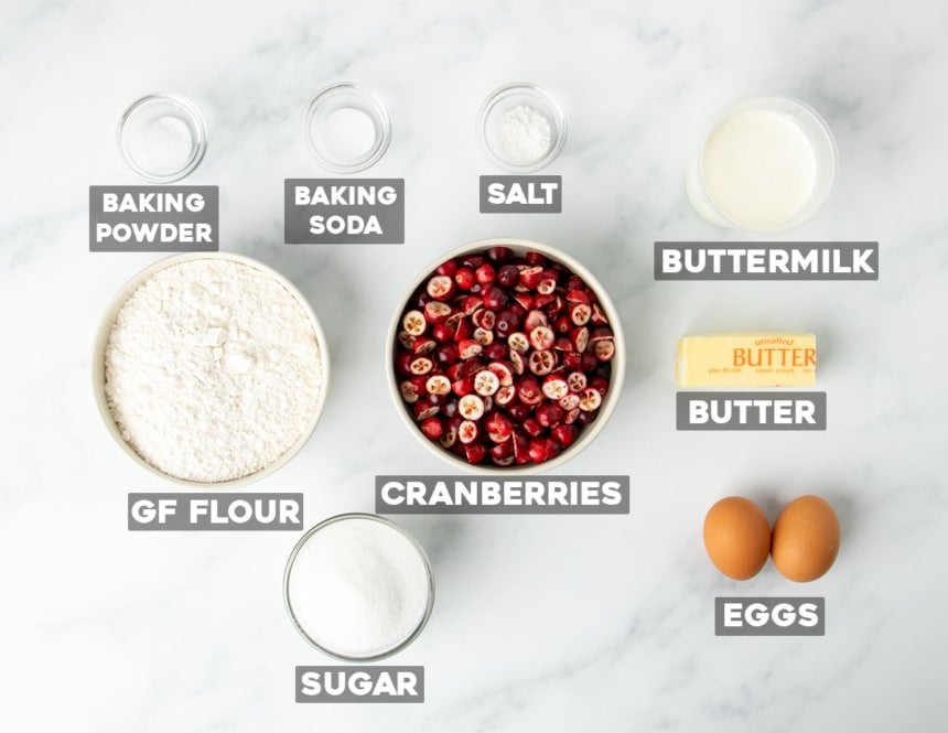 overhead image of gluten free cranberry bread ingredients in small bowls with words of ingredients