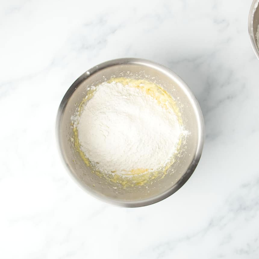 White flour mixture on top of yellow batter in same mixing bowl